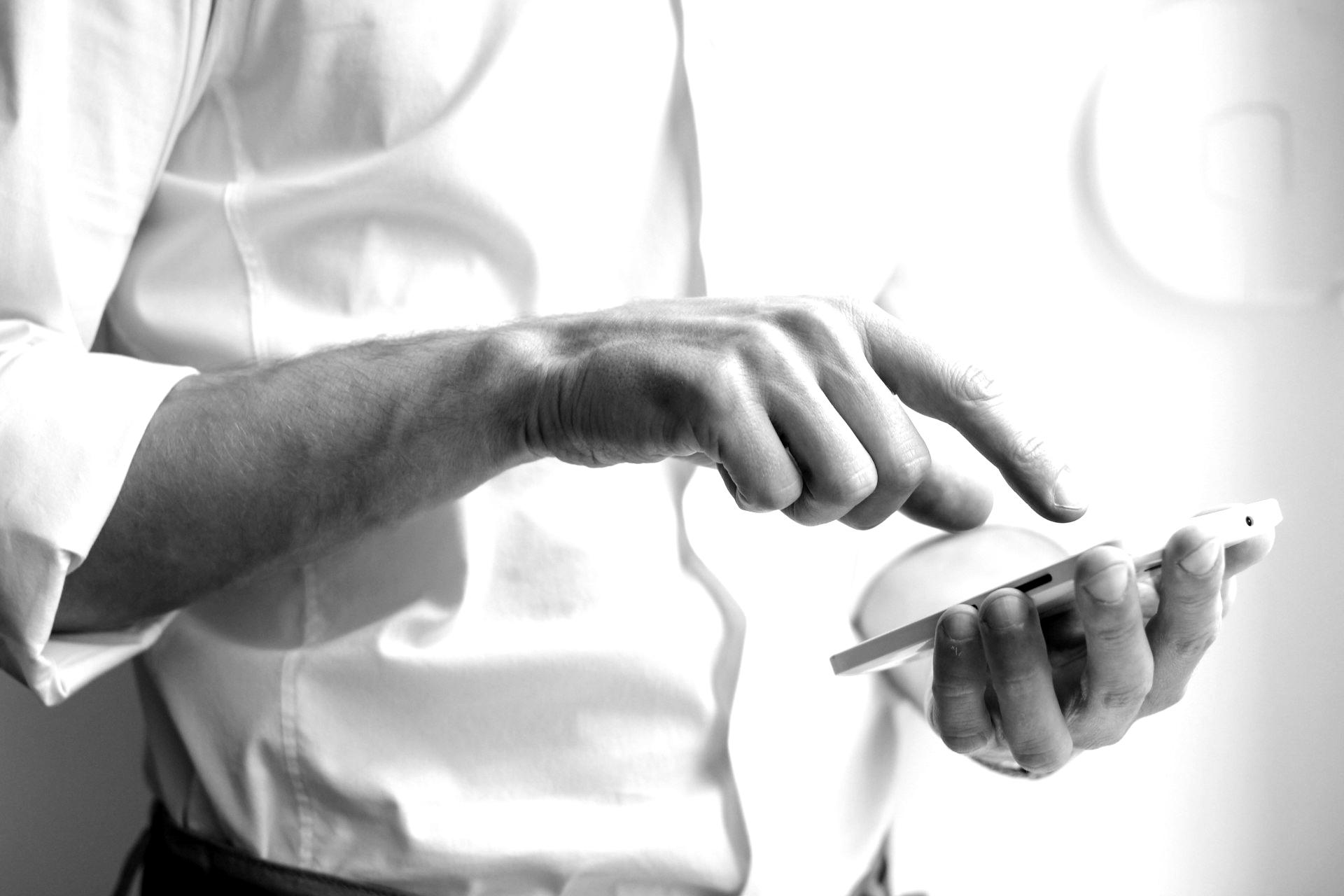 person holding white Android smartphone in white shirt